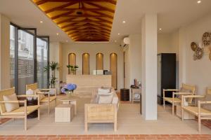 a lobby with chairs and tables in a building at Ten Boutique Hotel Oldtown Chiangmai in Chiang Mai +86 photos