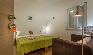 a room with a bed and a table with stuffed animals on it at Apartments and Rooms Bonkan Hvar in Hvar
