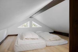 a bedroom with two white beds in a attic at 0660-Toftlund-Vestskoven-8 in Toftlund
