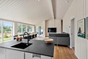 a kitchen with a sink and a living room at 0122-Romo-Smafolksvej-44 in Høm