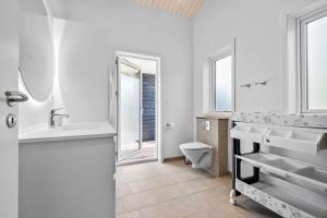 a white bathroom with a sink and a toilet at 0122-Romo-Smafolksvej-44 in Høm +15 photos