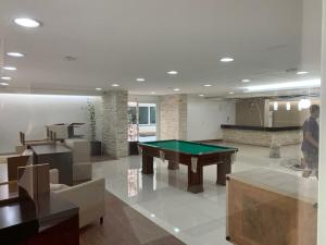 a living room with a pool table in it at Apto Cittá in Brasília