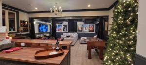 a living room with a christmas tree in the middle at Modern Loft with Immersive Theatre Experience in Milton