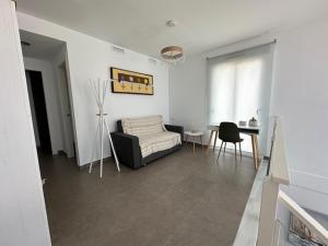 a living room with a couch and a table at Beach House Renata in Gran Alacant
