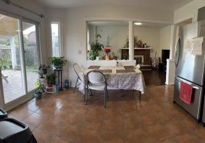 a living room with a table and a refrigerator at Bright private single bedroom V02 on second floor in Mississauga
