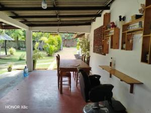 a dining room with a wooden table and chairs at SA Resort in Anuradhapura