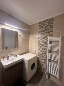 a bathroom with a washing machine and a sink at Ήρεμο σπίτι casa puente in Stenón +8 photos