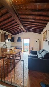 a living room with a blue couch and a table at Canto dei Merli in Greve in Chianti