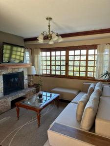 a living room with a couch and a coffee table at Pousada Constellation Lodge in Campos do Jordão