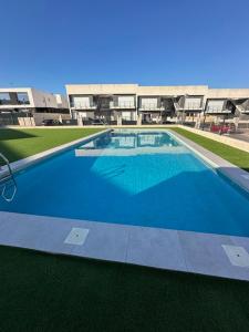 a large swimming pool in front of a building at Beach House Renata in Gran Alacant