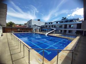 a swimming pool on the roof of a building at Hotel Agua Azul Melgar Tolima in Melgar