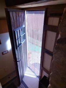 an open door with a window in a room at Casa Quimera para dos in Gilgarcía +22 photos