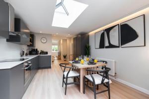 a kitchen and dining room with a table and chairs at Stunning Montpellier Retreat in Cheltenham