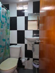 a bathroom with a toilet and a sink at P.N Manchineel road Providence Island ECORELAX in Providencia