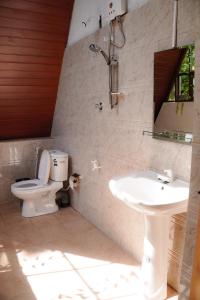 een badkamer met toilet en wastafel bij Coco Breeze Cabanas - free Airport pick up or drop off in Katunayaka +21 foto's