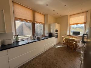 バッキーにあるStrathlene House Retreat - 5 bed deluxe Business or Holiday Accommodationのテーブルとダイニングルームのあるキッチン