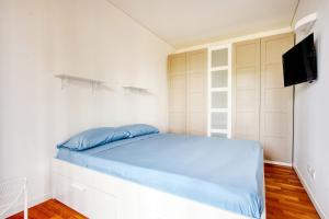 a small bedroom with a bed and a tv at GiaxTower Gym Spa & Pool Romantic Pool View in Milan
