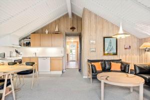 a living room with a couch and tables and a kitchen at 0300-Romo-Vestergade-3-Ap-73 in Havneby +22 photos