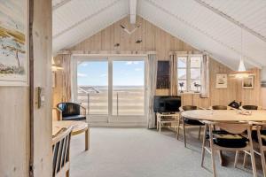 a dining room with tables and a view of the ocean at 0300-Romo-Vestergade-3-Ap-73 in Havneby