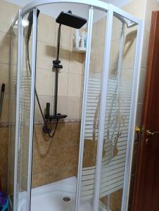 a shower with a glass door in a bathroom at Aldo's apartments in Pogradec +14 photos
