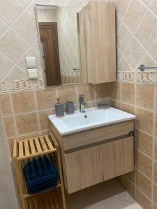 a bathroom with a sink and a mirror at Appartement OCEAN VIEW in Tamraght Ouzdar