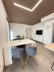 a dining room with a white table and chairs at Dream House Pool Garda Lake - Castelnuovo del Garda in Cavalcaselle