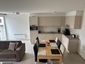 a kitchen and living room with a table and a couch at Rotessa in Blankenberge