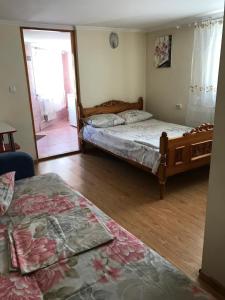 a bedroom with two beds and a mirror at Квартира in Chernivtsi