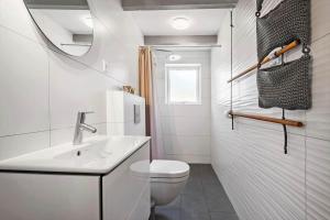 a white bathroom with a sink and a toilet at 0209-Romo-Vrabyvej-34 in Vesterhede +18 photos