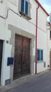 a wooden door on the side of a building at El Terral in Sant Vicenç de Montalt
