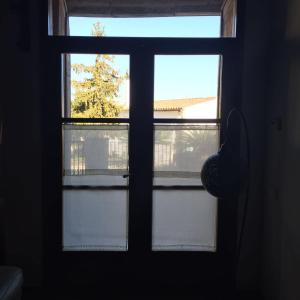 an open window with two views of a tree at El Terral in Sant Vicenç de Montalt