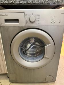 a washing machine with its door open in a kitchen at Golf porto marina pool view in El Alamein