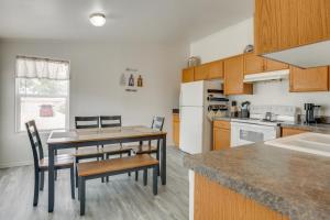 a kitchen with a table and chairs and a kitchen with white appliances at 1 Mi to Main Street Cozy Retreat in Portales in Portales