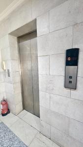 a building with a pay phone on a wall at High Altitude Makkah - Aziziya Spacious Flat in Makkah