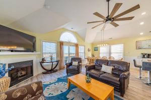 a living room with a couch and a fireplace at K1023 Dream Weaver - Oceanfront, Private Pool, Private Beach Walkway! Pets OK! in Nags Head