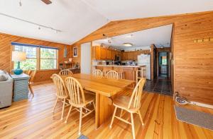 a kitchen and dining room with a wooden table and chairs at Duck Redux - Ocean Dunes, Oceanside, 350 Yds to Beach, One Level, Pets OK, Walk to Downtown in Duck +25 photos