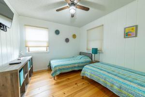 a bedroom with two beds and a ceiling fan at Duck Redux - D0416 in Duck