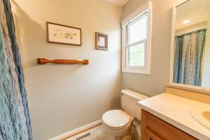 a bathroom with a toilet and a sink and a window at Duck Redux - D0416 in Duck +25 photos