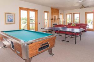 a living room with two ping pong tables in it at D0597 Dune Fine - Duck Landing Amenities, Pool, Hot Tub, Pets OK, Keyless! in Duck