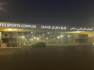 a car parked in front of a gas station at night at Joude in Fez +5 photos