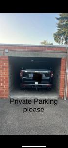 a black car is parked in a garage at Appartement in Sint-Truiden