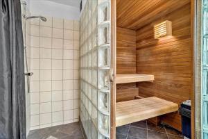 a sauna with wooden walls and wooden shelves in a bathroom at 0286-Romo-Sonder-Frankel-34 in Havneby +16 photos