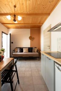 a kitchen and living room with a couch in the background at Agreste Agriturismo in Sassoferrato