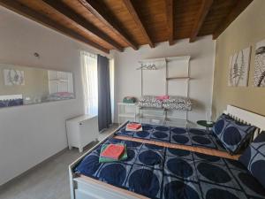 a bedroom with a large bed in a room at La casa di Edone in Monzambano