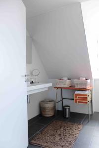 a bathroom with a table and a sink at Loft d'architecte - vue sur port et deco vintage in Paimpol