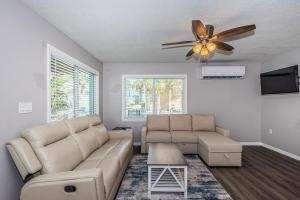 a living room with a couch and a ceiling fan at 2 Bedroom Beachside Suite in Clearwater Beach