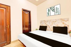 a bedroom with a bed with two laptops on it at The Krishna's Bliss in Ghaziabad