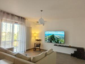 a living room with a couch and a tv on the wall at Apartment Pescantina in Pescantina