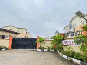 a driveway in front of a building with a fence at Orchard Block 5 in Alagbado