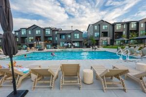 a swimming pool with chairs and people in a building at Wasatch Peak Chateau Unit A with Pool and Hot Tub in Mountain Green